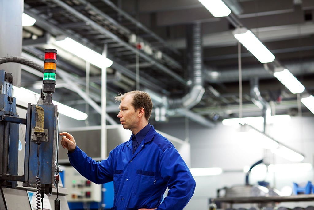 Worker in blue overalls