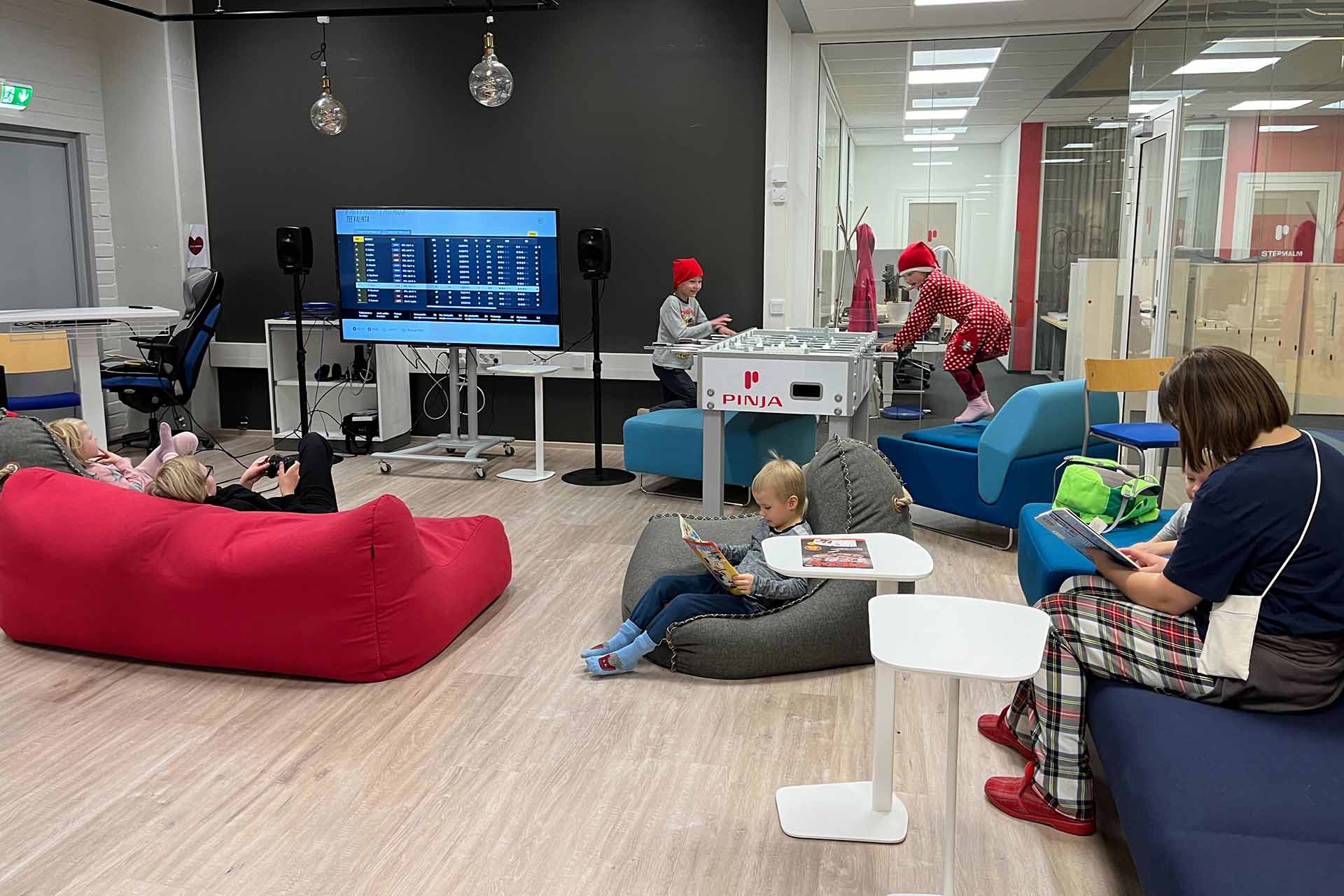 Children sitting on beanbags reading and playing in the office