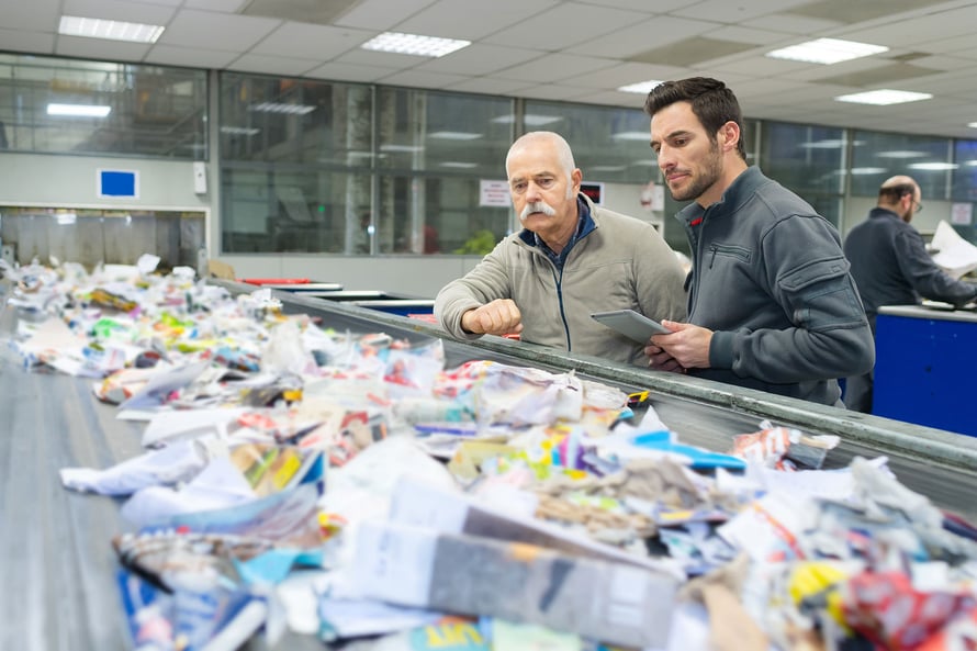 Men looking at waste