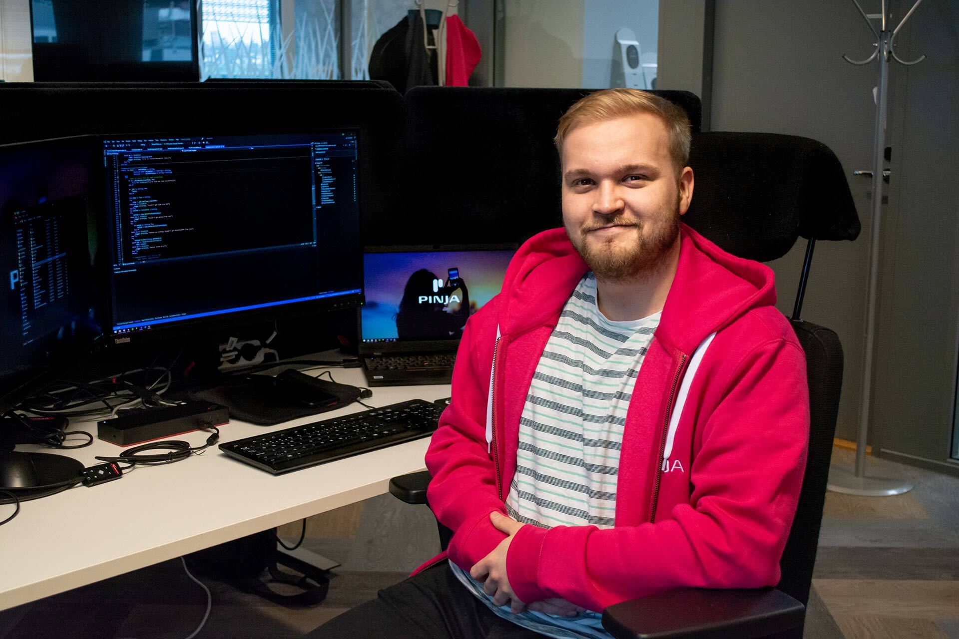 Hannu Kujanpää who completed his practical training at Pinja sitting in front of two computer screens